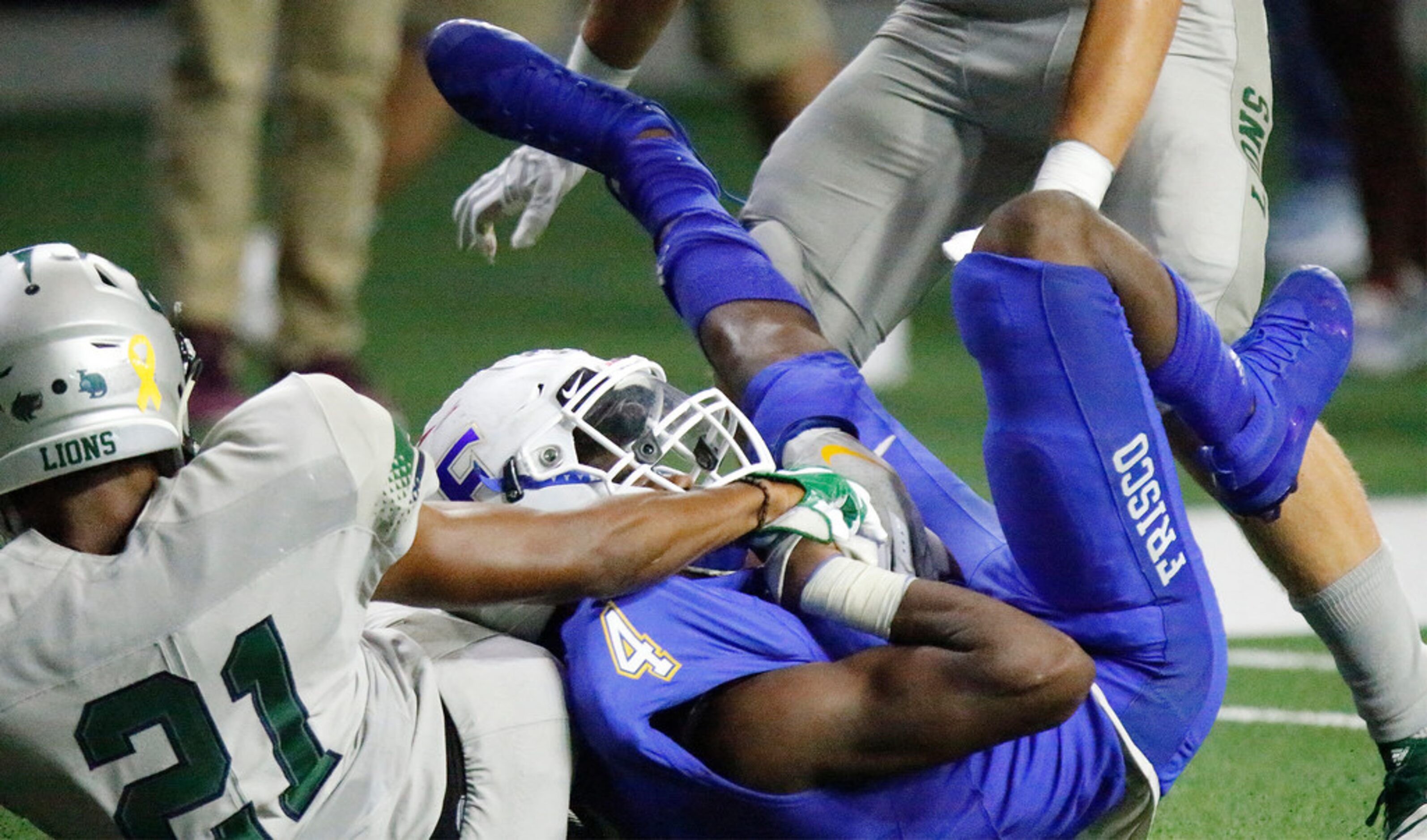 Frisco High School wide receiver Chase Lowery (4) makes a catch for a first down as Reedy...