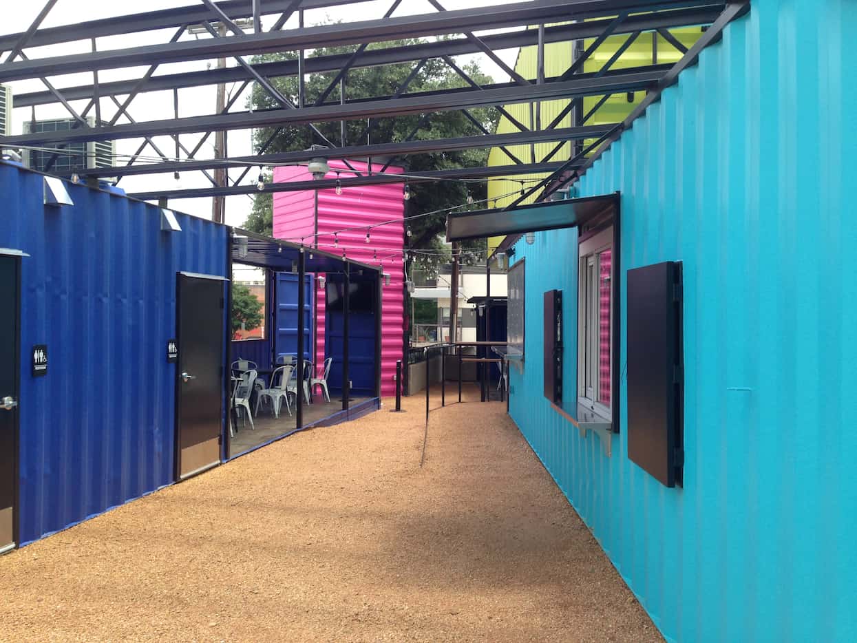 Old shipping containers have been repurposed on Akard Street outside the Lorenzo Hotel into...