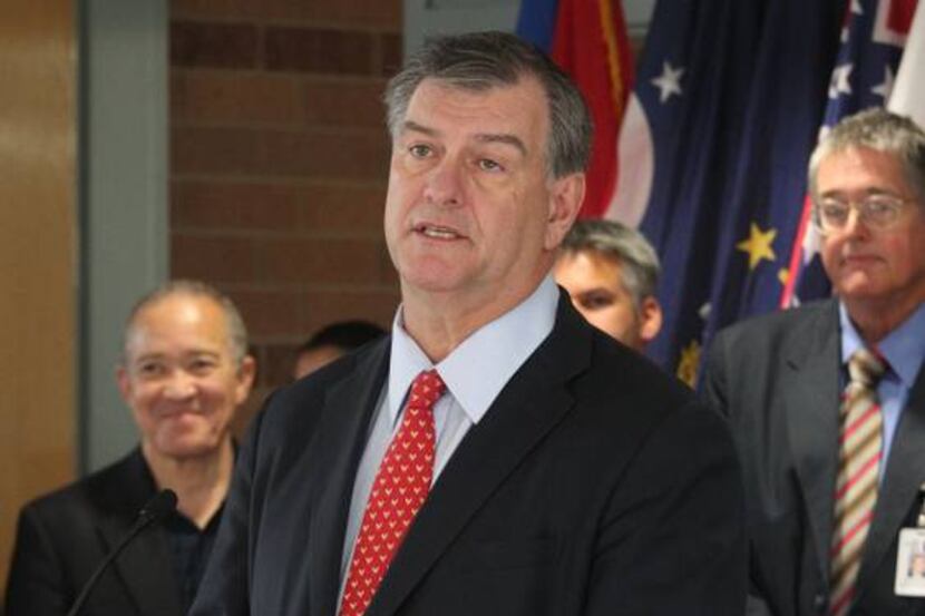 New DISD Superintendent Mike Miles (left) listened to Dallas Mayor Mike Rawlings speak at...