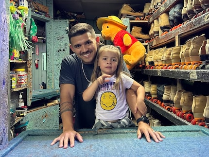 Jacob Candanoza and his daughter, Amethyst, pose at the Cedar Hill Roller Rink, owned by...