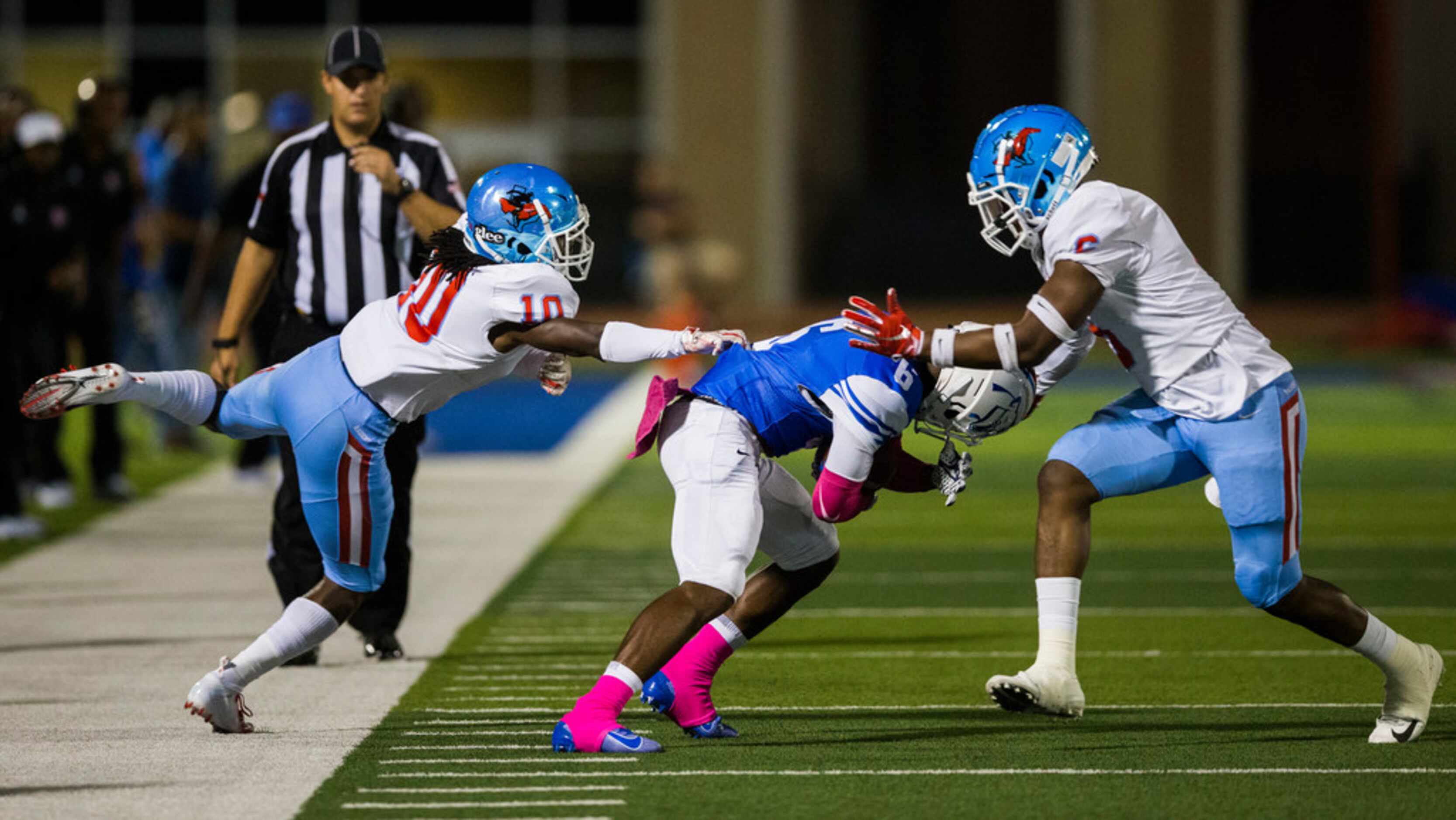 Duncanville wide receiver Marquelan Crowell (6) is tackled by Skyline defensive back Milton...