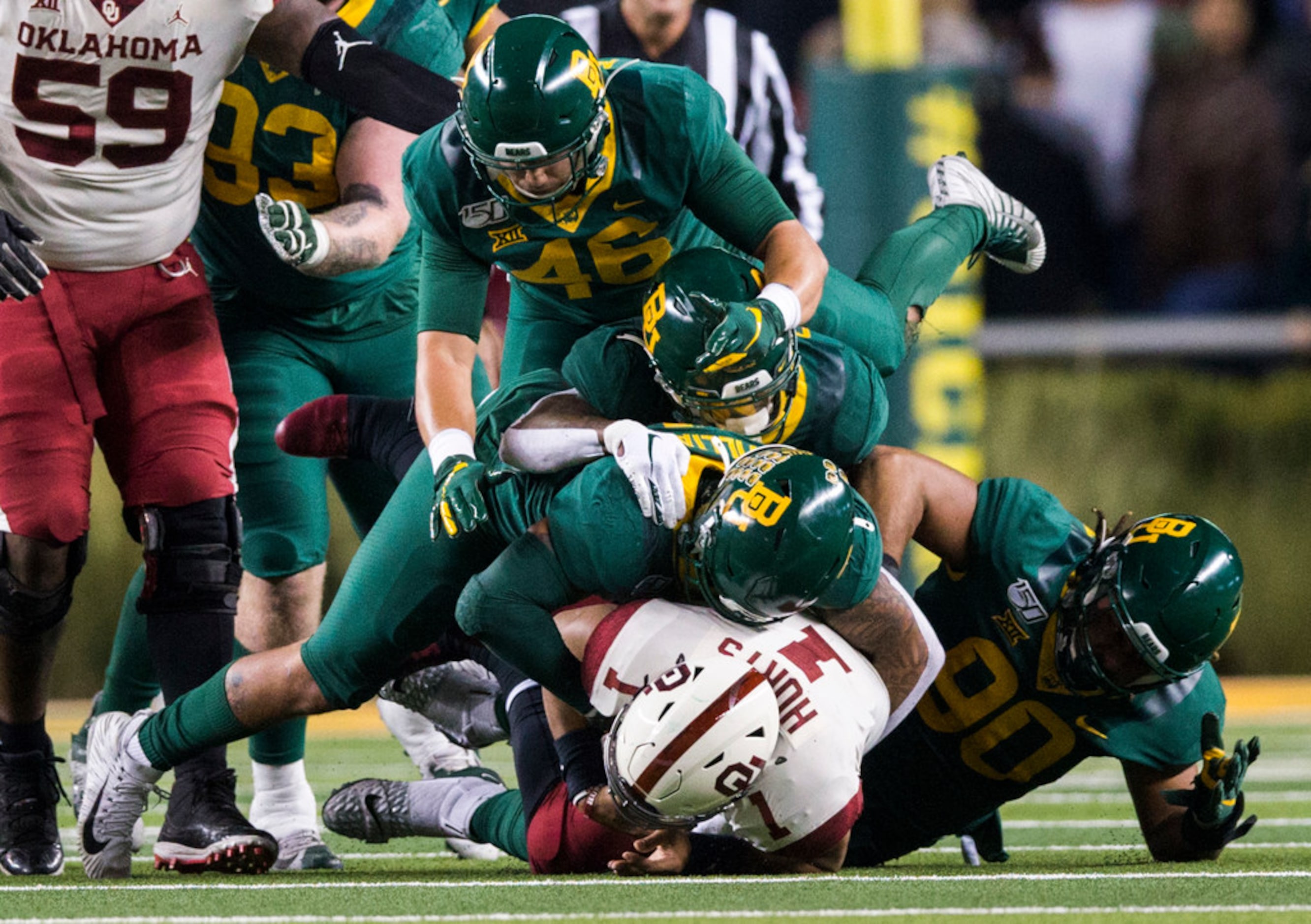 Oklahoma Sooners quarterback Jalen Hurts (1) is sacked by Baylor Bears defenders during the...