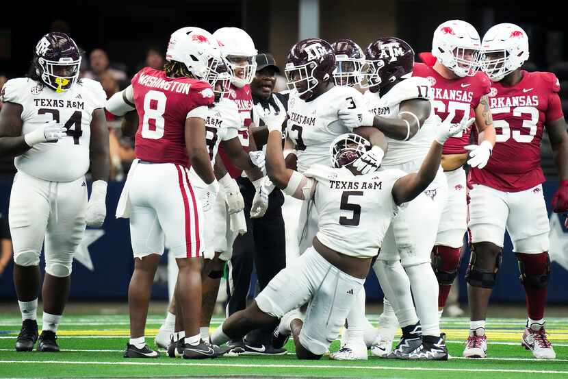 Texas A&M defensive lineman Shemar Turner (5) gets tangled up after a play during the second...