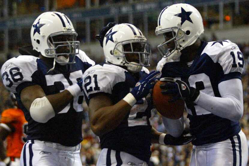 Dallas Cowboys #21 Julius Jones, center, gets his touchdown ball from #19 Keyshawn Johnson...