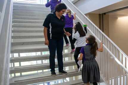 La directora Nancy Bernardino saluda a las estudiantes de la escuela Solar Preparatory...