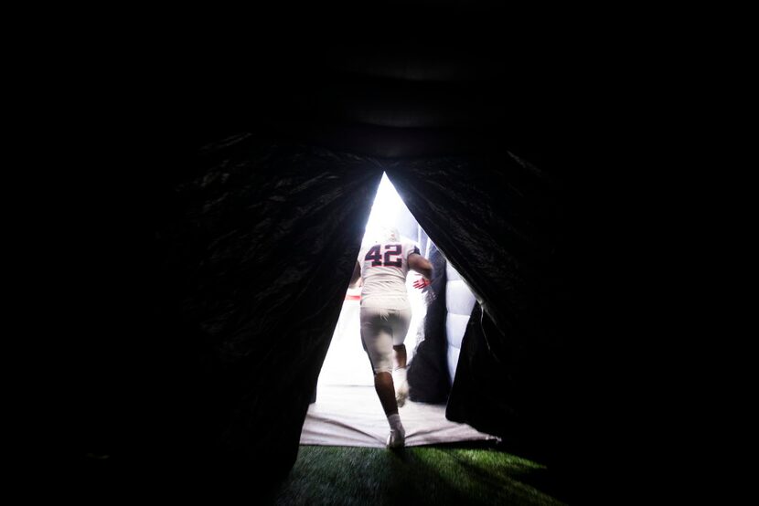 Allen defensive lineman Jayden Jernigan (42) is the last player out of the tunnel as the...