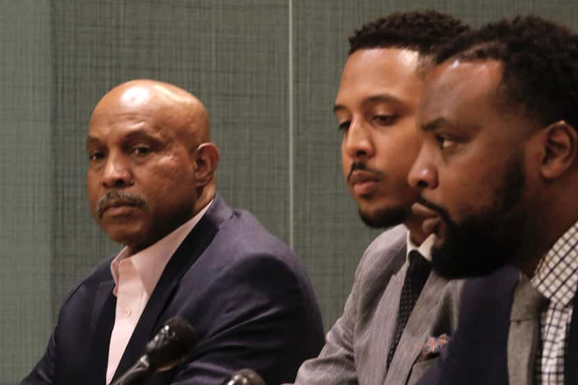 From left: Rashad Madden’s father, James Madden, listens to attorneys Justin Moore and Lee...