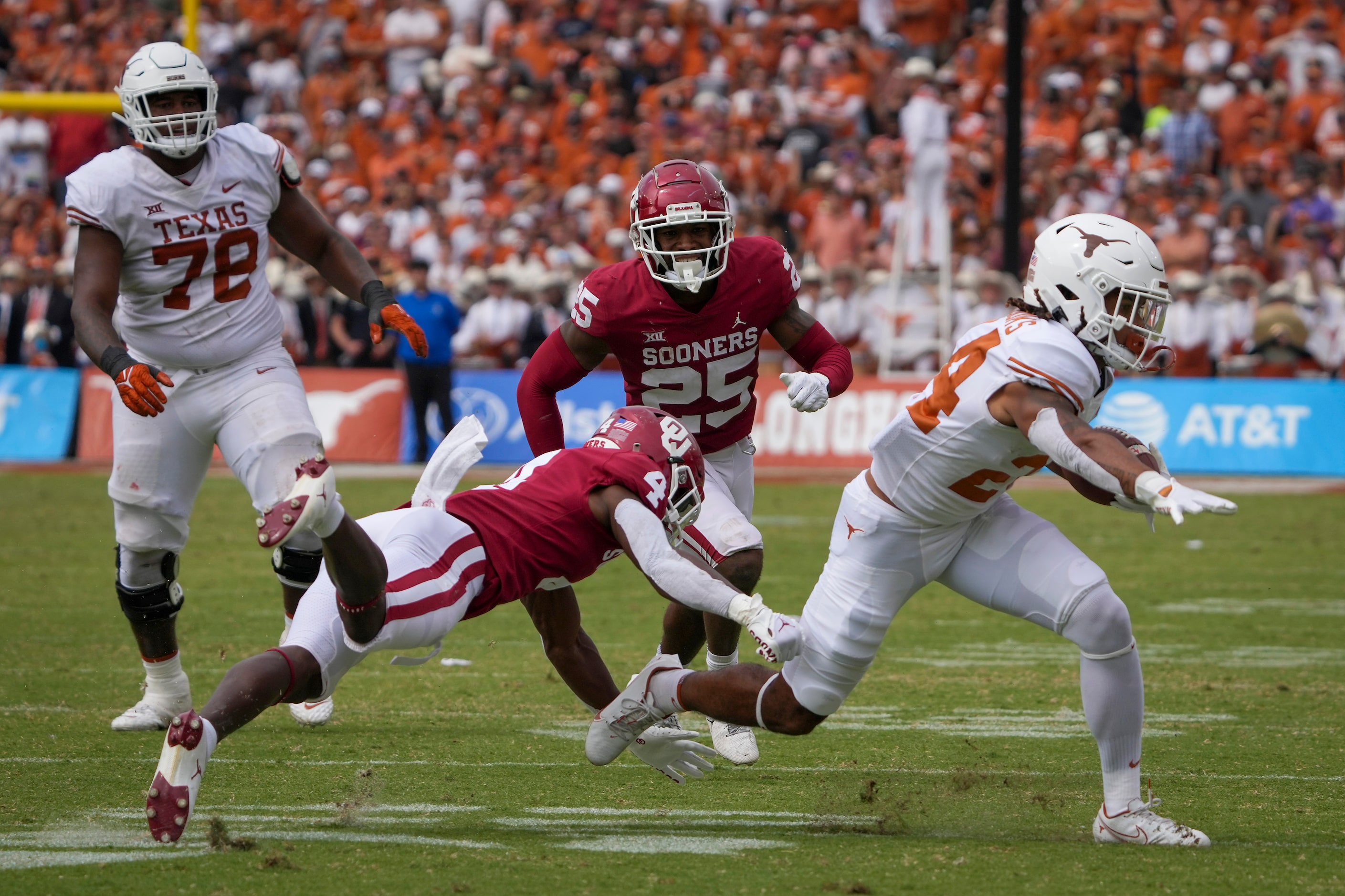 Texas running back Jonathon Brooks (24) gets past Oklahoma defensive back Jaden Davis (4)...