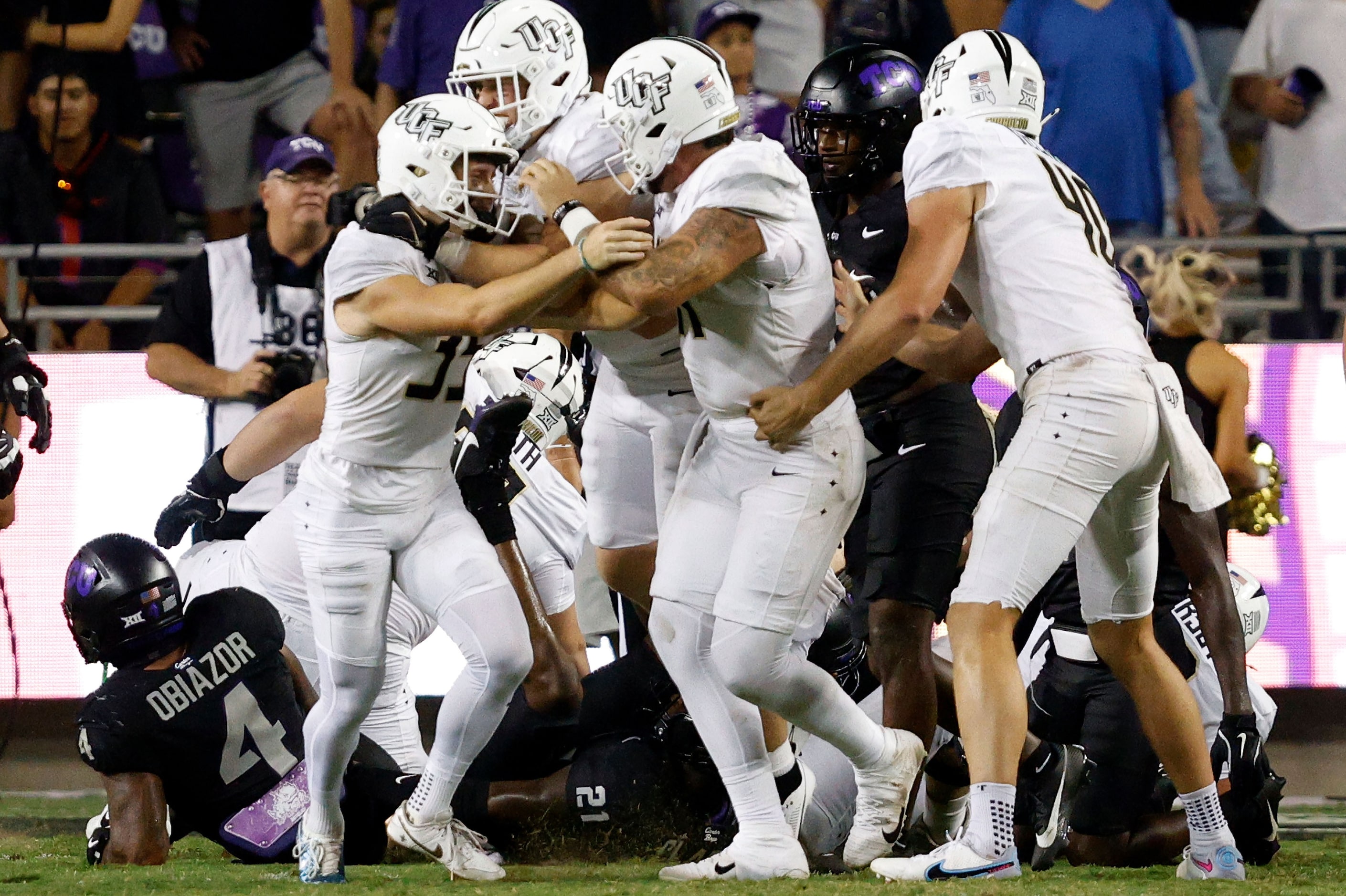 UCF place kicker Colton Boomer (35), left, celebrates with his teammates after scoring his...