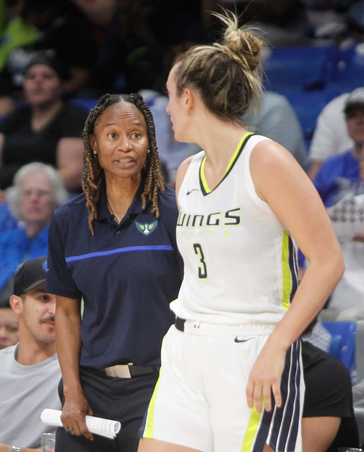 Dallas Wings head coach Vickie Johnson shares some game strategy with Wings guard Marina...