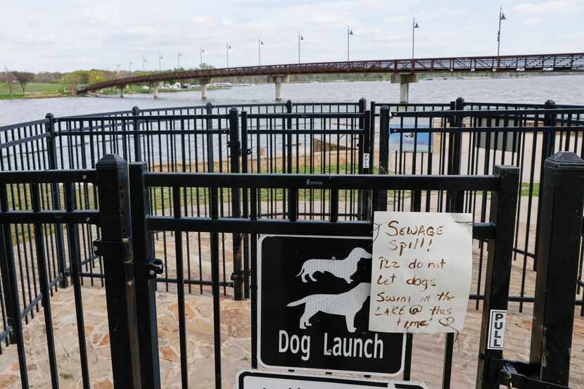 A sign warns dog owners not to let their pets swim in White Rock Lake after 1.5 million...