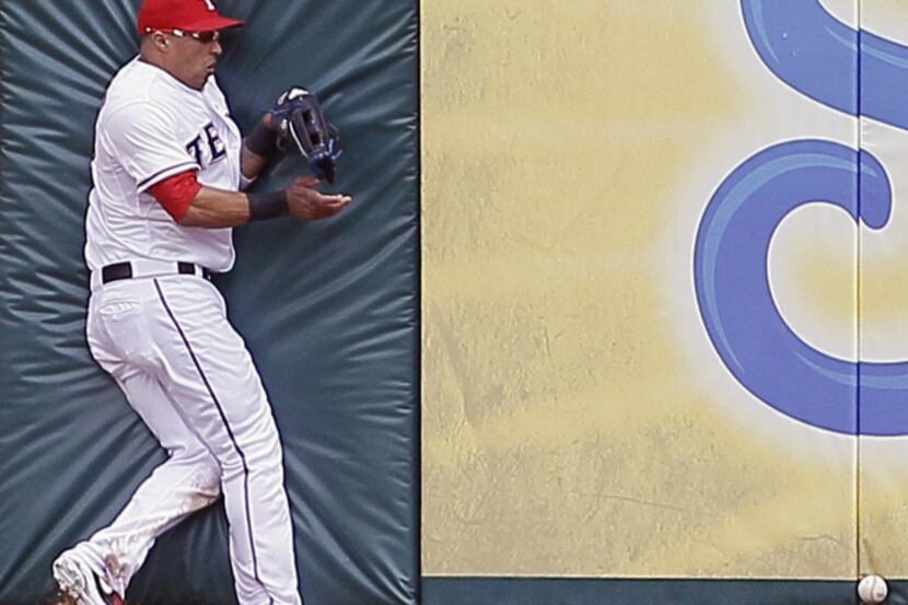 Texas Rangers center fielder Leonys Martin (2) loses a ball hit by Seattle Mariners' Michael...