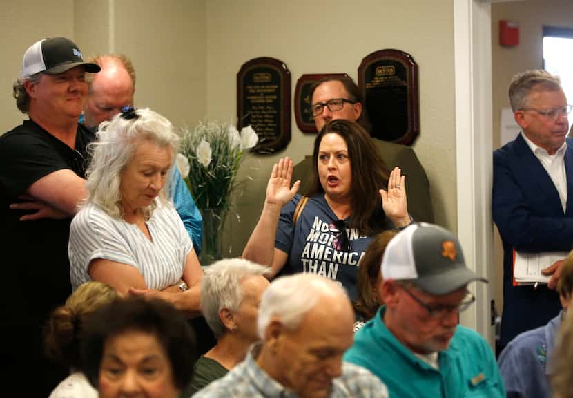 Jennifer Jolly reacts during a town hall meeting in Gunter, Texas, Thursday evening, April...