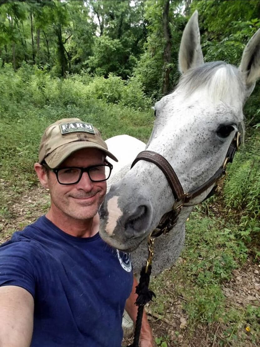 Veteran and Equest volunteer Jeff Hensley takes a selfie with his Equest horse, Tez, while...
