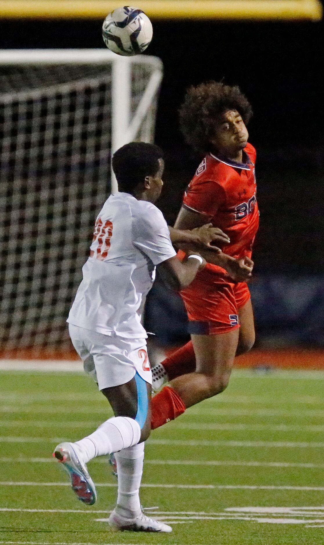 Caleb Sempebwa (3) gets a header over Allen High School forward Osi Iyamah (20) during the...