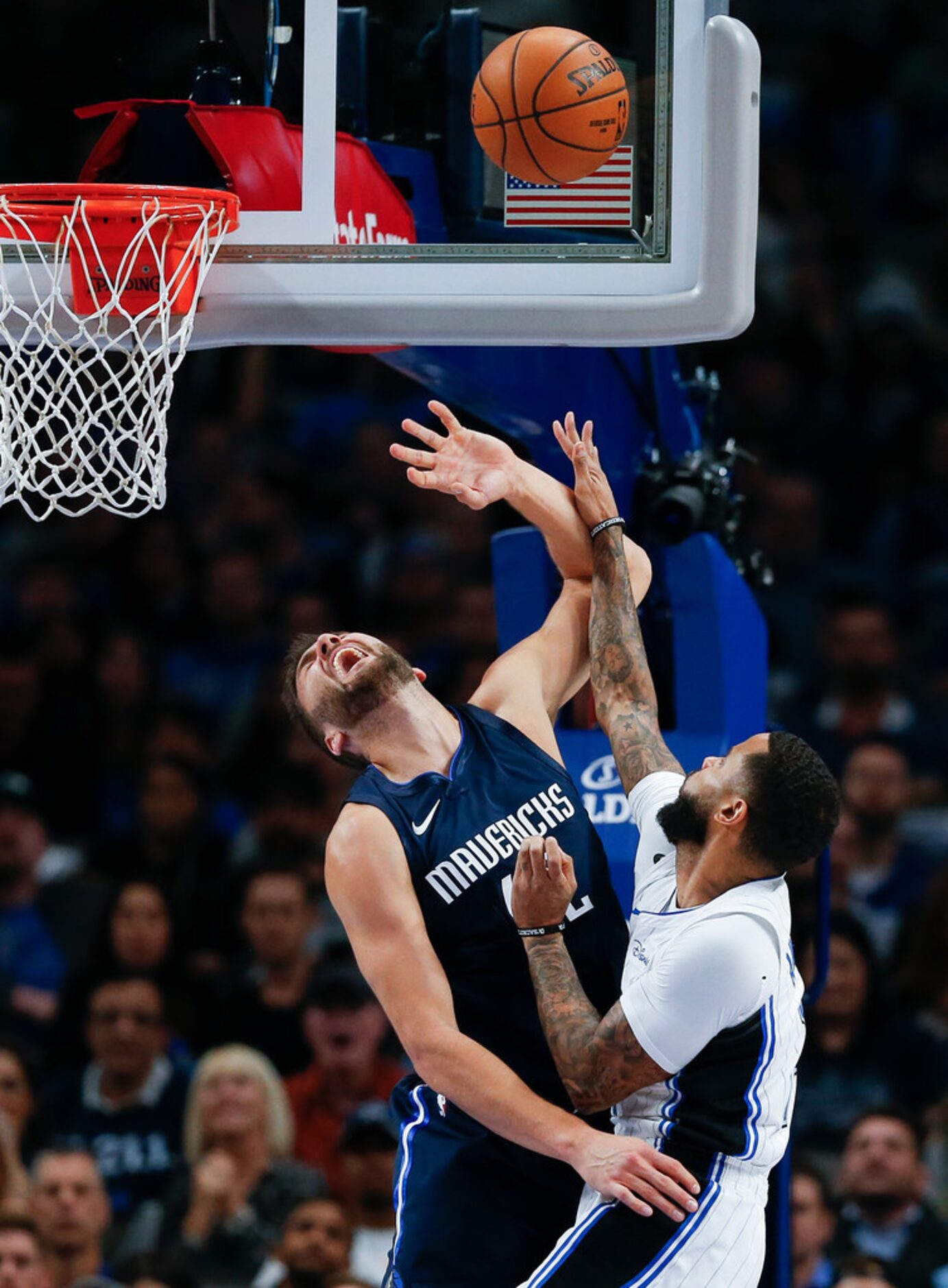 Orlando Magic guard D.J. Augustin (14) gets a shot off over Dallas Mavericks center Maxi...