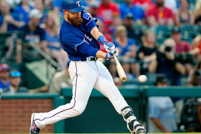 With bases loaded in the third inning, Texas Rangers catcher Jonathan Lucroy connects on a...