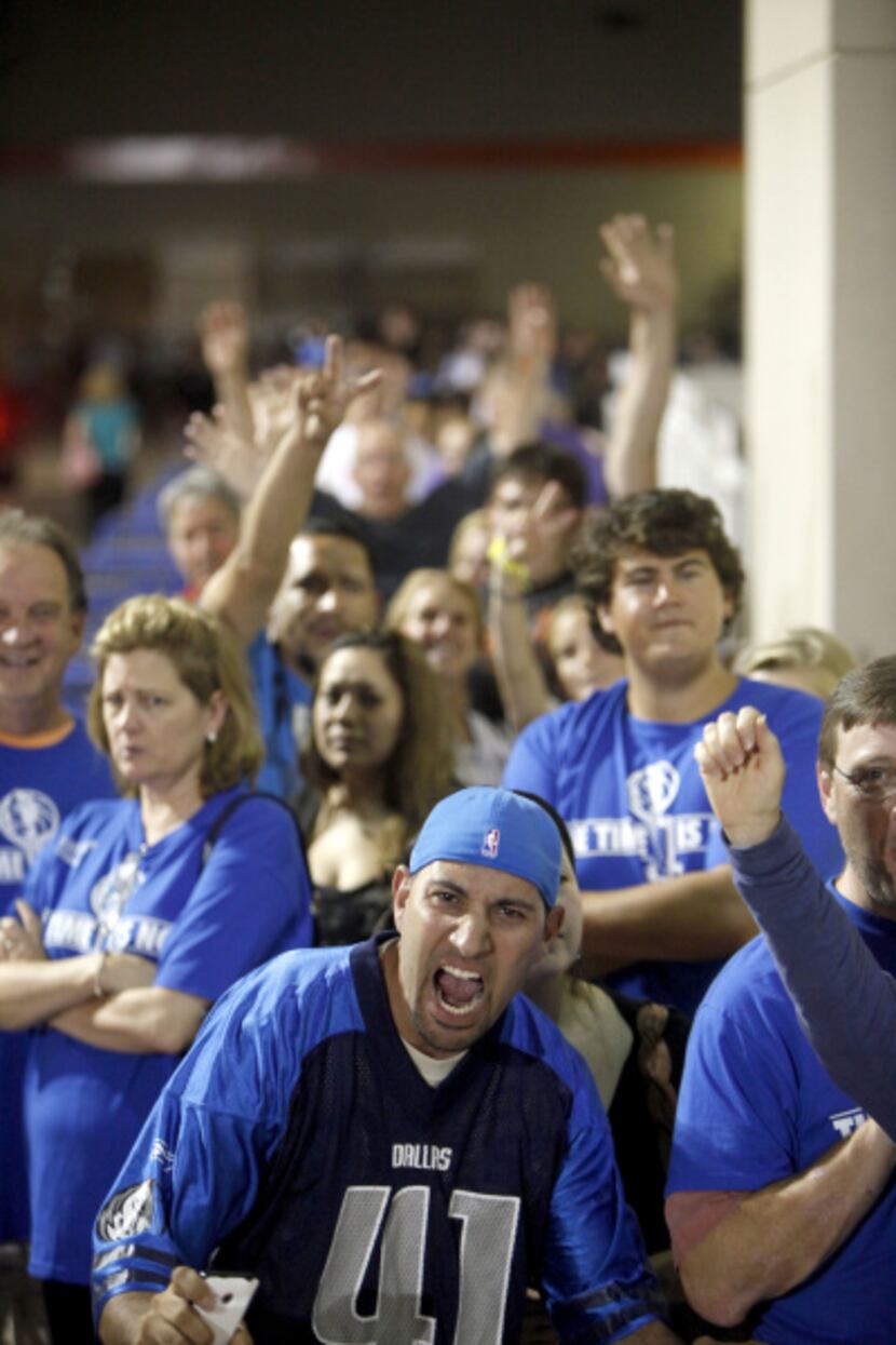 Dallas Mavs fans show there enthusiasm while waiting in line to purchase official...