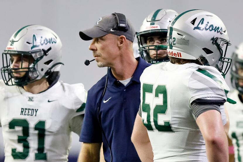Frisco Reedy head coach Chad Cole (center) and his players look for a ruling on the field...