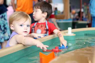 Water tables are part of the fun at Moody Family Children's Museum inside the Perot Museum...