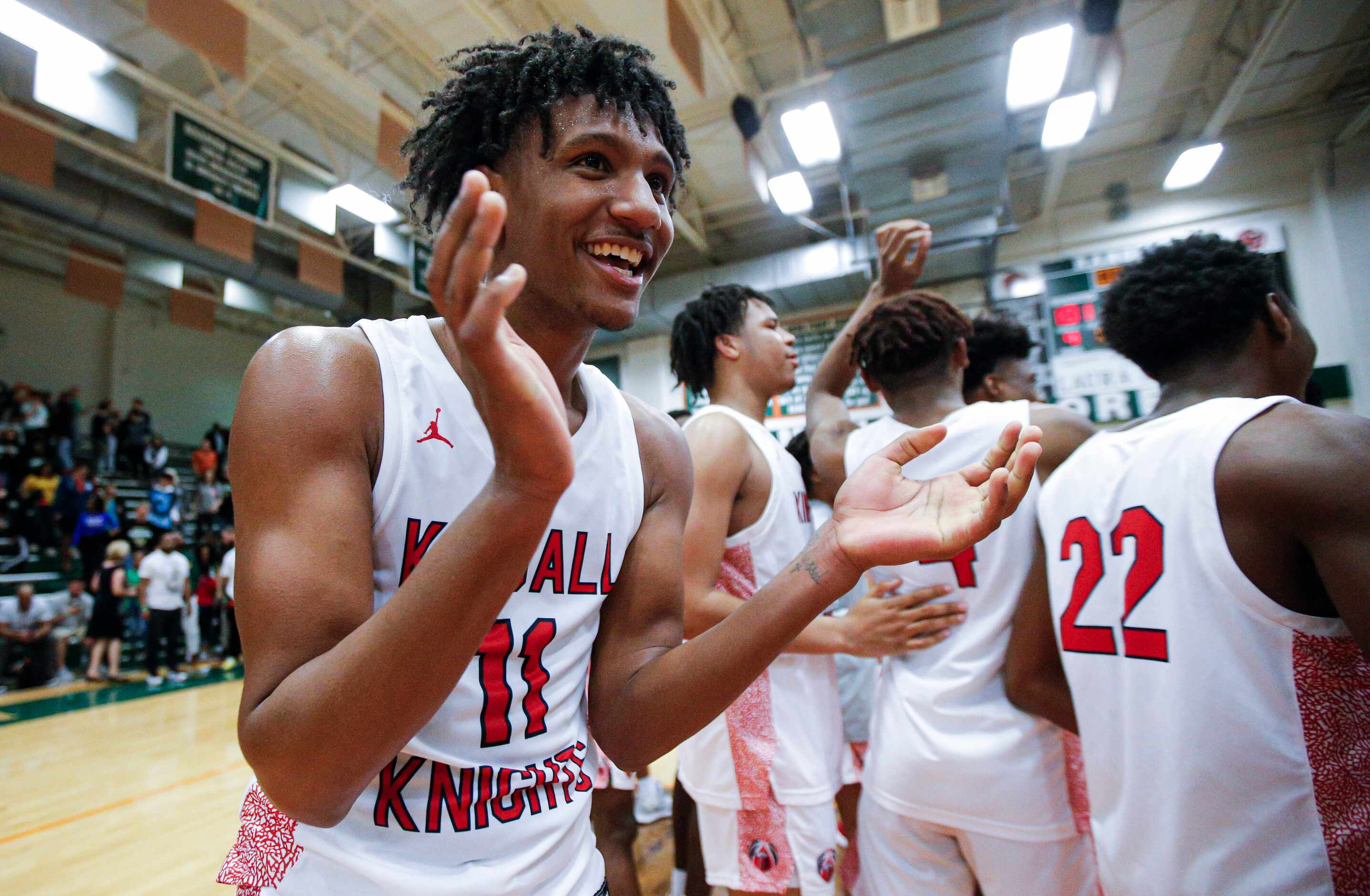 Kimball senior Cory Reynolds celebrates a 101-73 win over Newman Smith after a Class 5A...