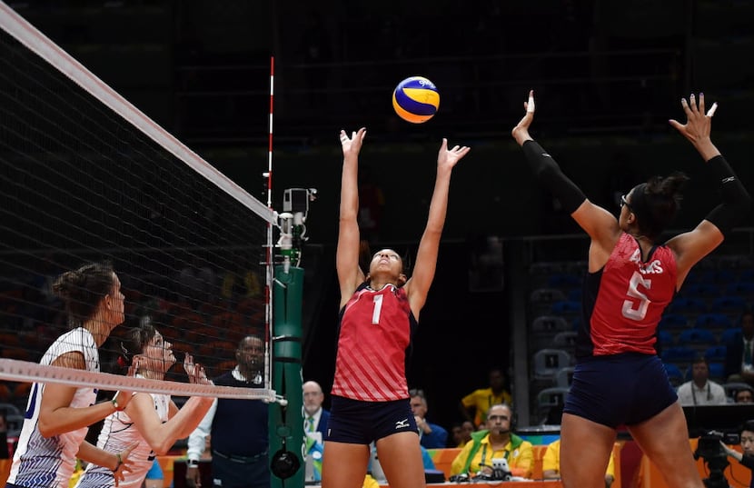 USA's Rachael Adams (R) prepares to spike the ball during the women's qualifying volleyball...