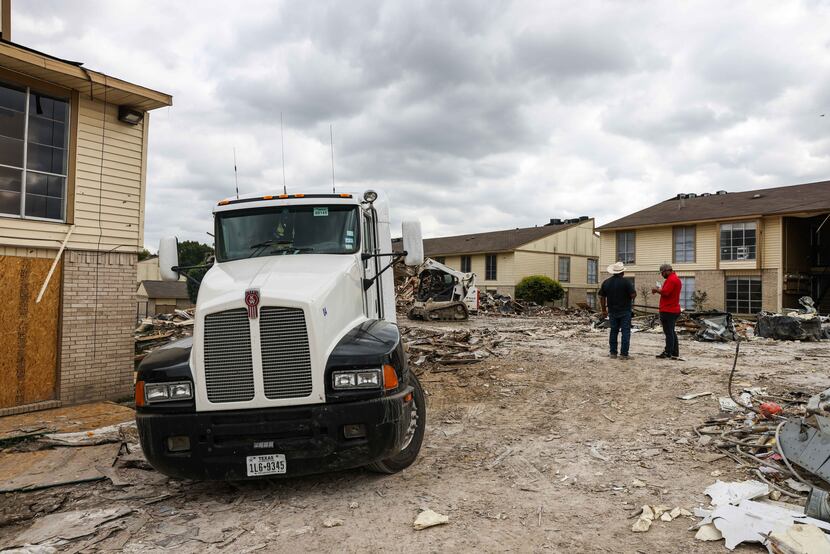 Debris removal work is carried out in the apartment complex at 5700 Highland Hills in Dallas...