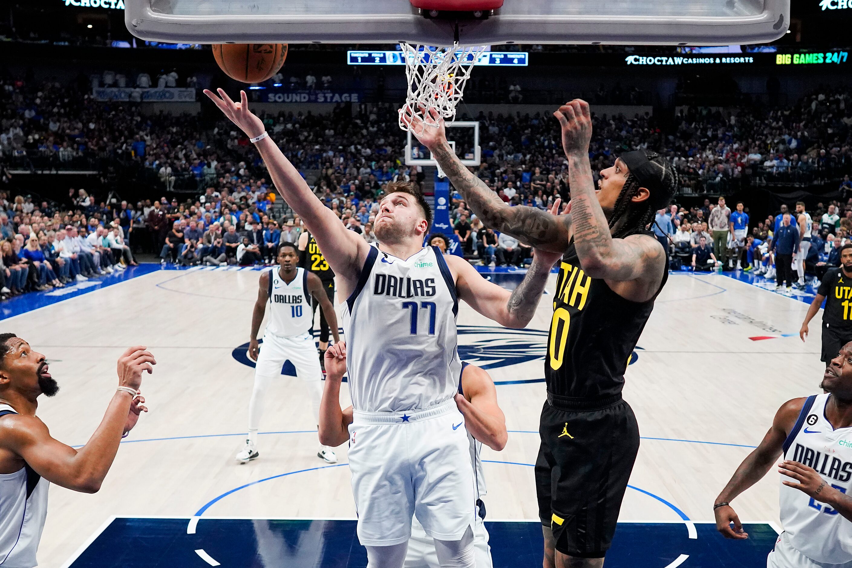 Dallas Mavericks guard Luka Doncic (77) grabs a rebound away from Utah Jazz guard Jordan...