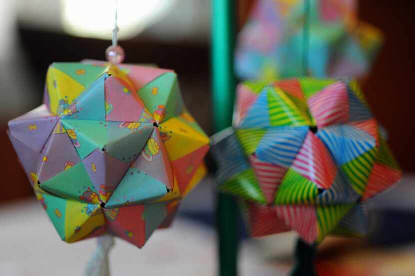 Each of the girls’ origami ornaments takes several hours to complete and is made in the...