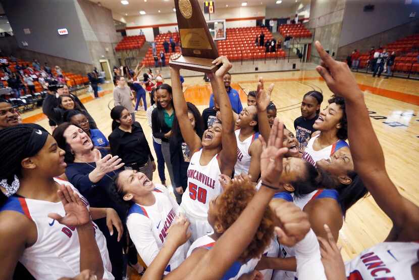 Duncanville's girls basketball team celebrate their 62-49 win over South Grand Prairie in...