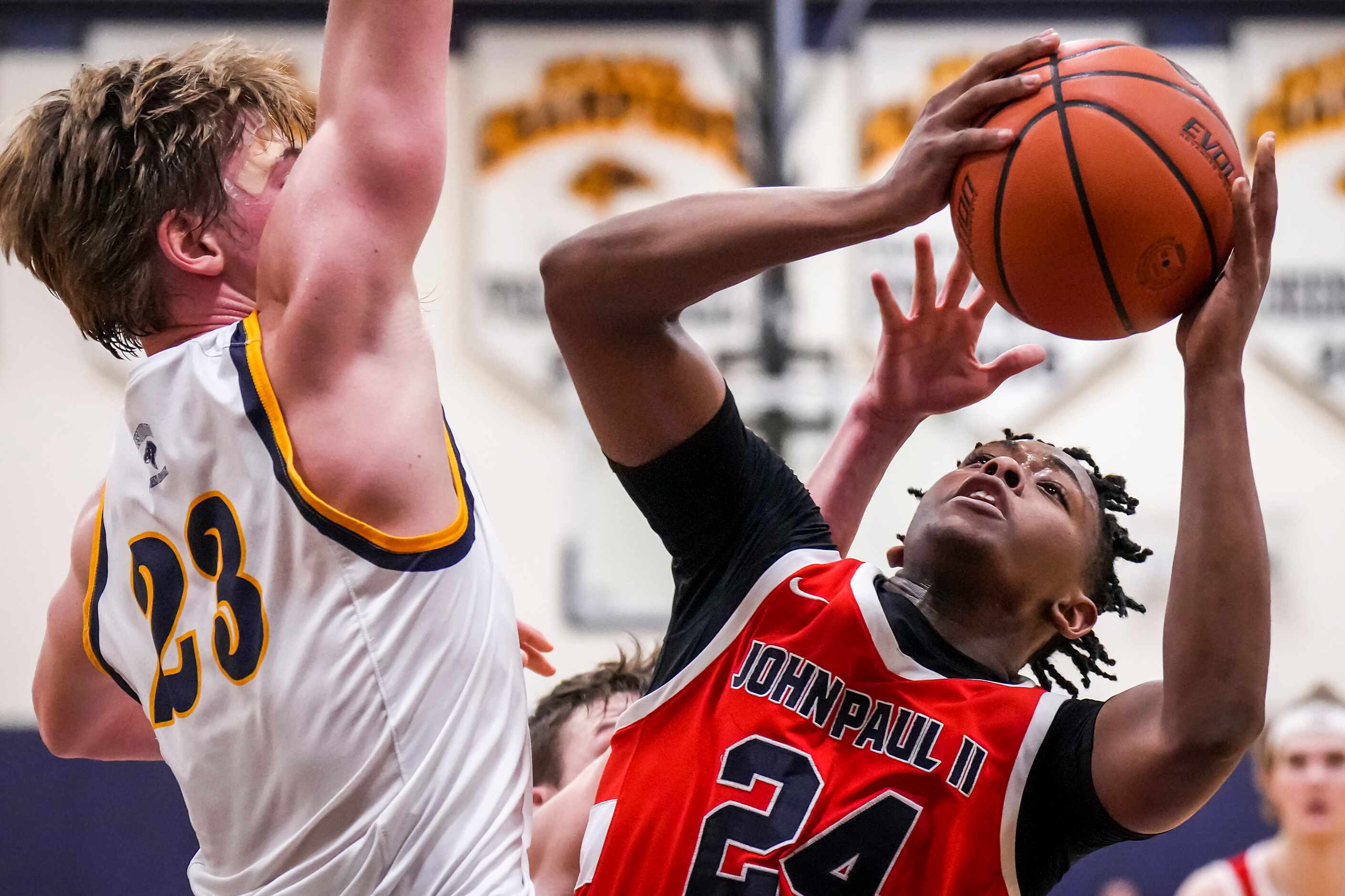 John Paul II's RJ Jones (24) drives to the basket against Prestonwood Christian's Matthew...