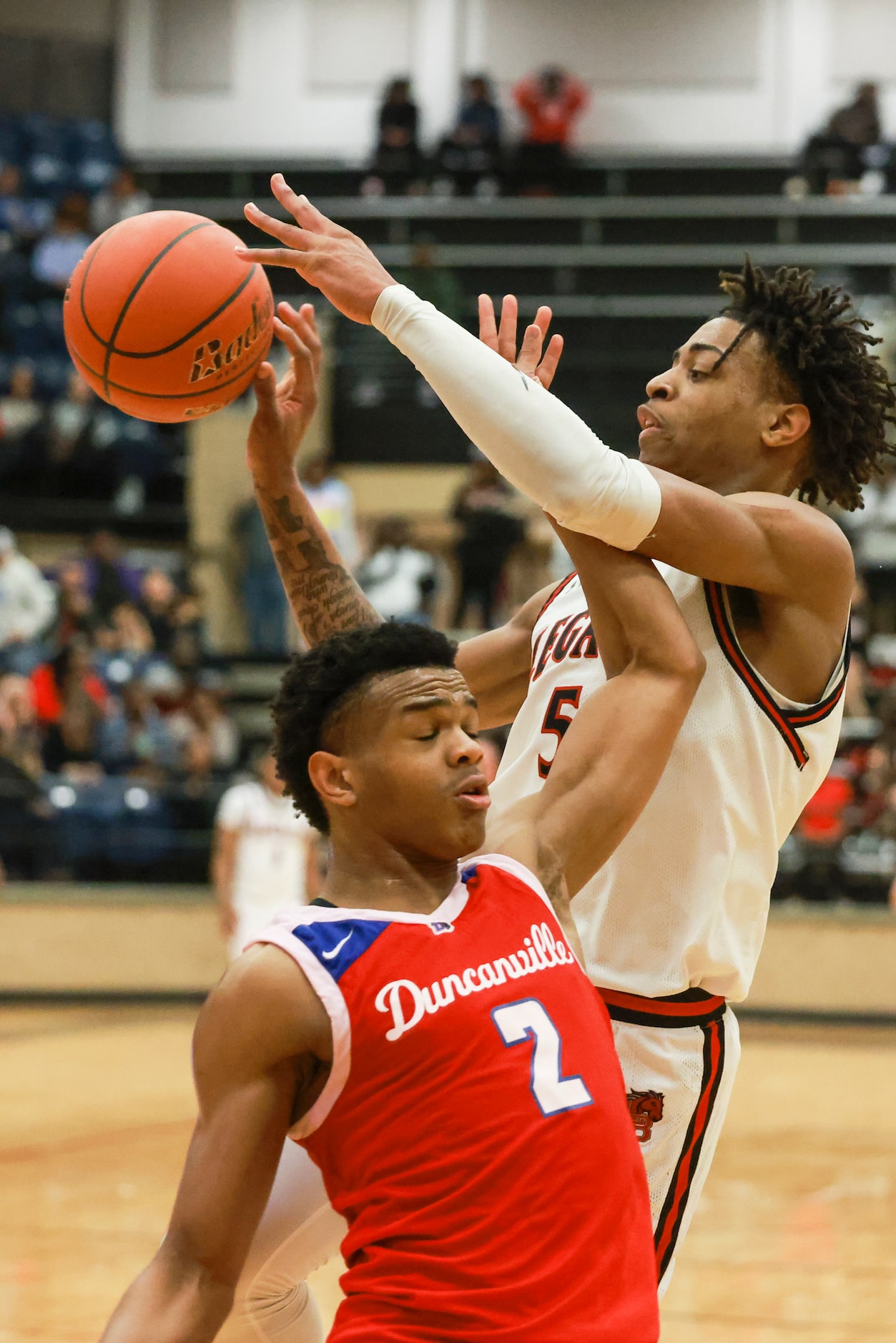 Mansfield Legacy High School’s Ahmare Rose (5) passes over Duncanville High School’s Evan...