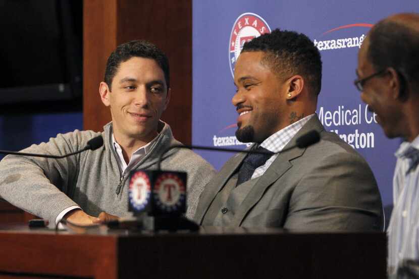 The Texas Rangers GM Jon Daniels, left, shake hands with Prince Fielder while introducing...