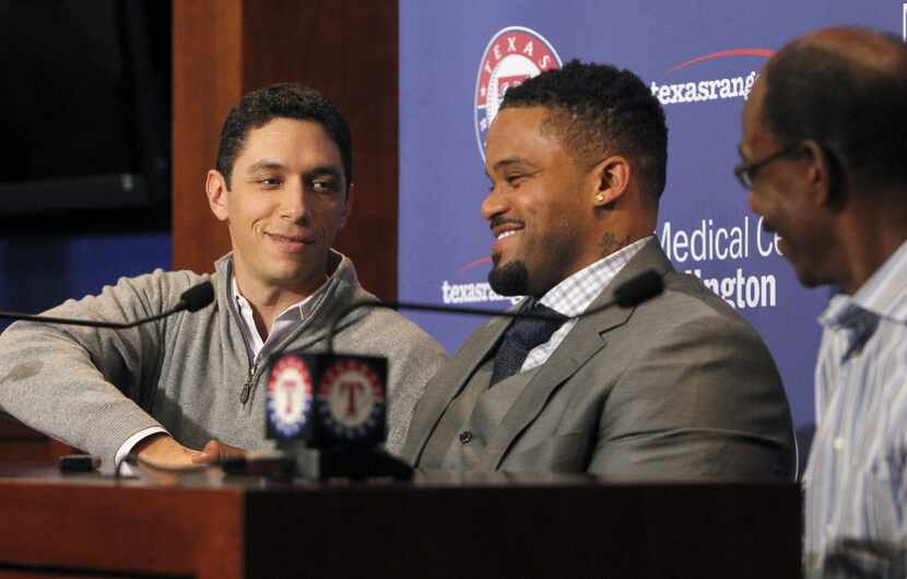 The Texas Rangers GM Jon Daniels, left, shake hands with Prince Fielder while introducing...