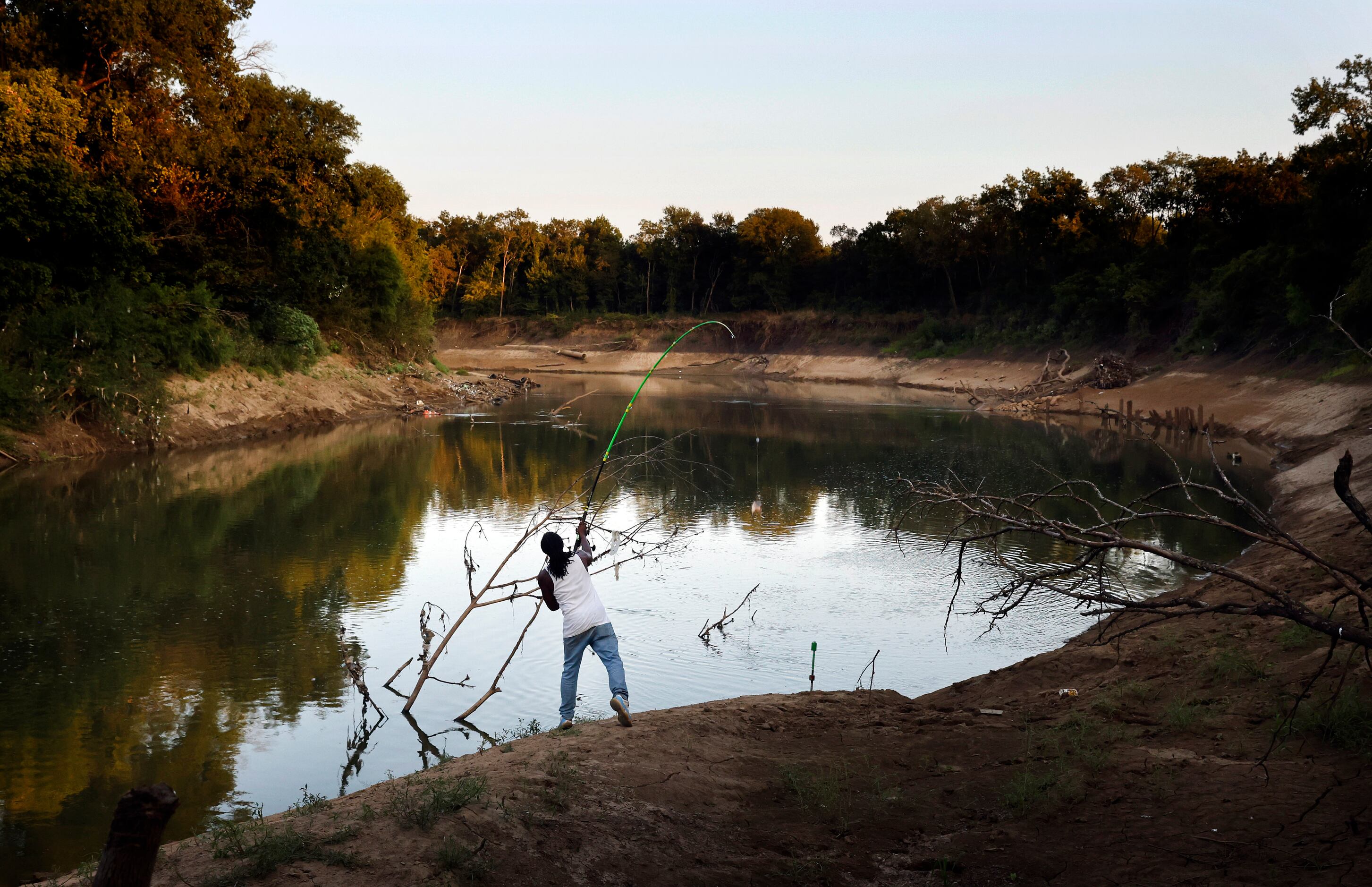 Odell Allen cast his line in hopes of reeling in an alligator gar on the Trinity River near...