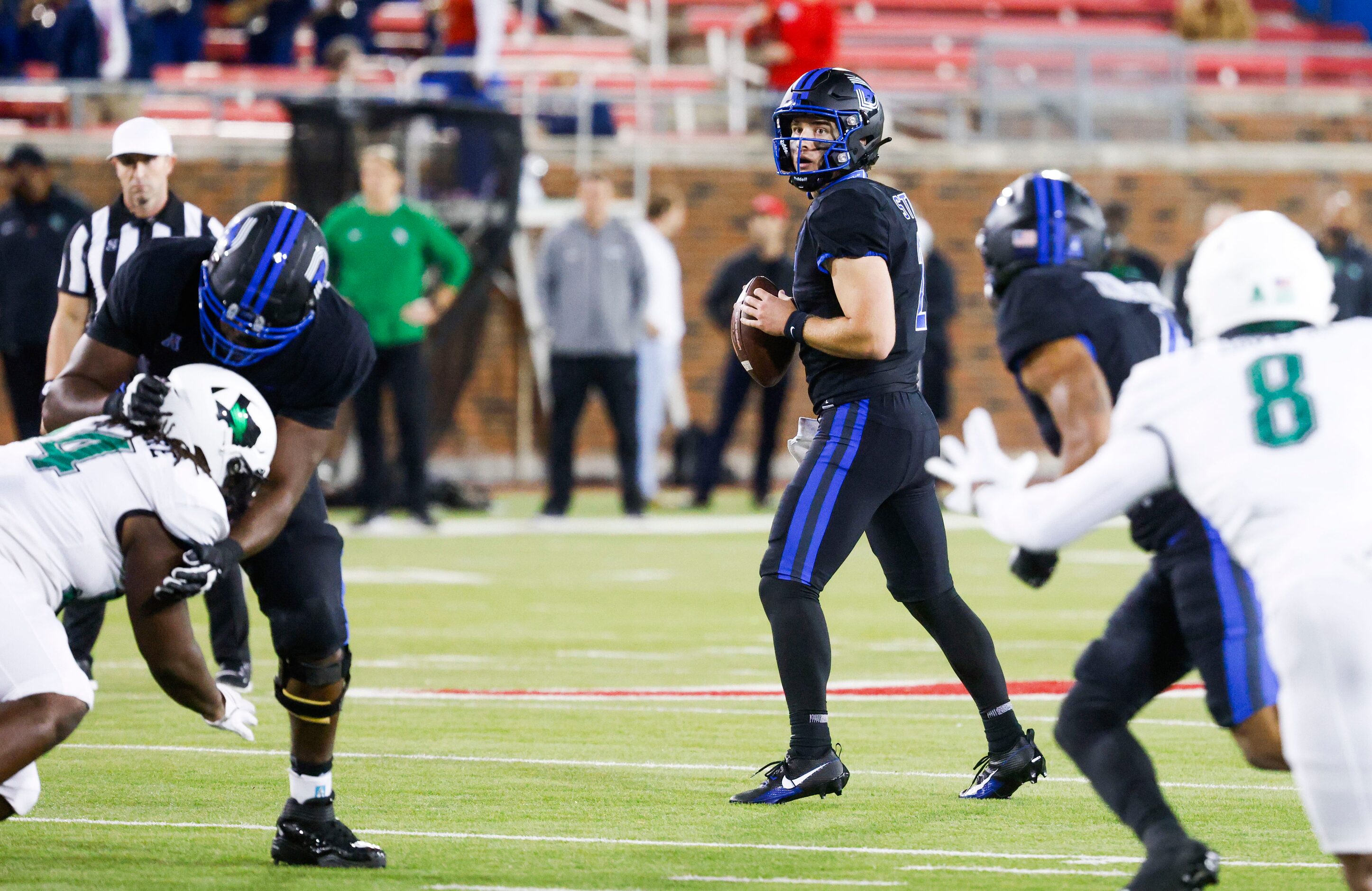 Southern Methodist Mustangs quarterback Preston Stone (center) looks to throw the ball...