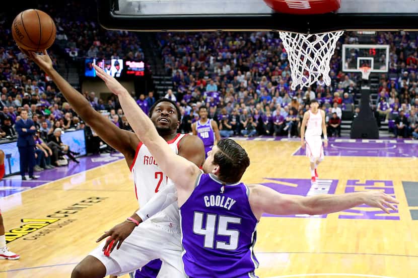 Houston Rockets center Chinanu Onuaku, let, goes to the basket against Sacramento Kings...