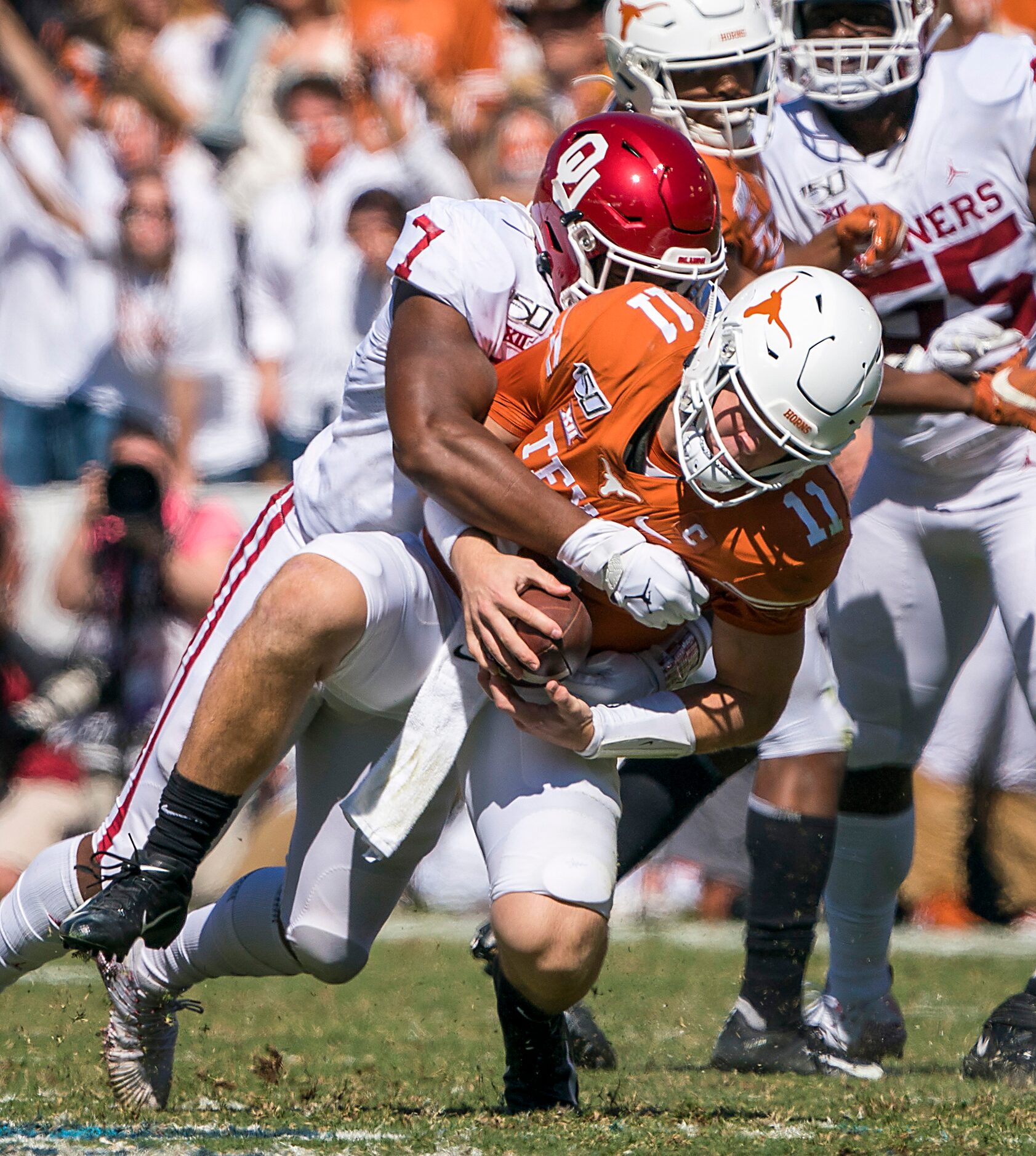 Texas quarterback Sam Ehlinger (11) is sacked by Oklahoma defensive lineman Ronnie Perkins...