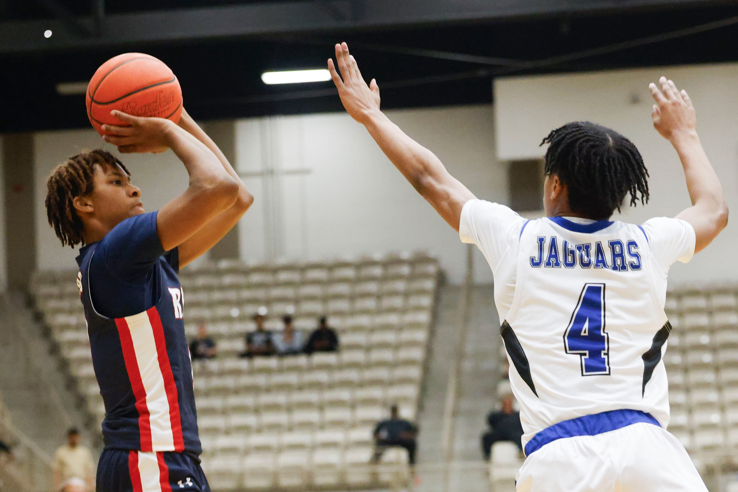 Denton Ryan’s DeMichael Brooks (left) shoots a three-pointer as Mansfield Summit’s David...