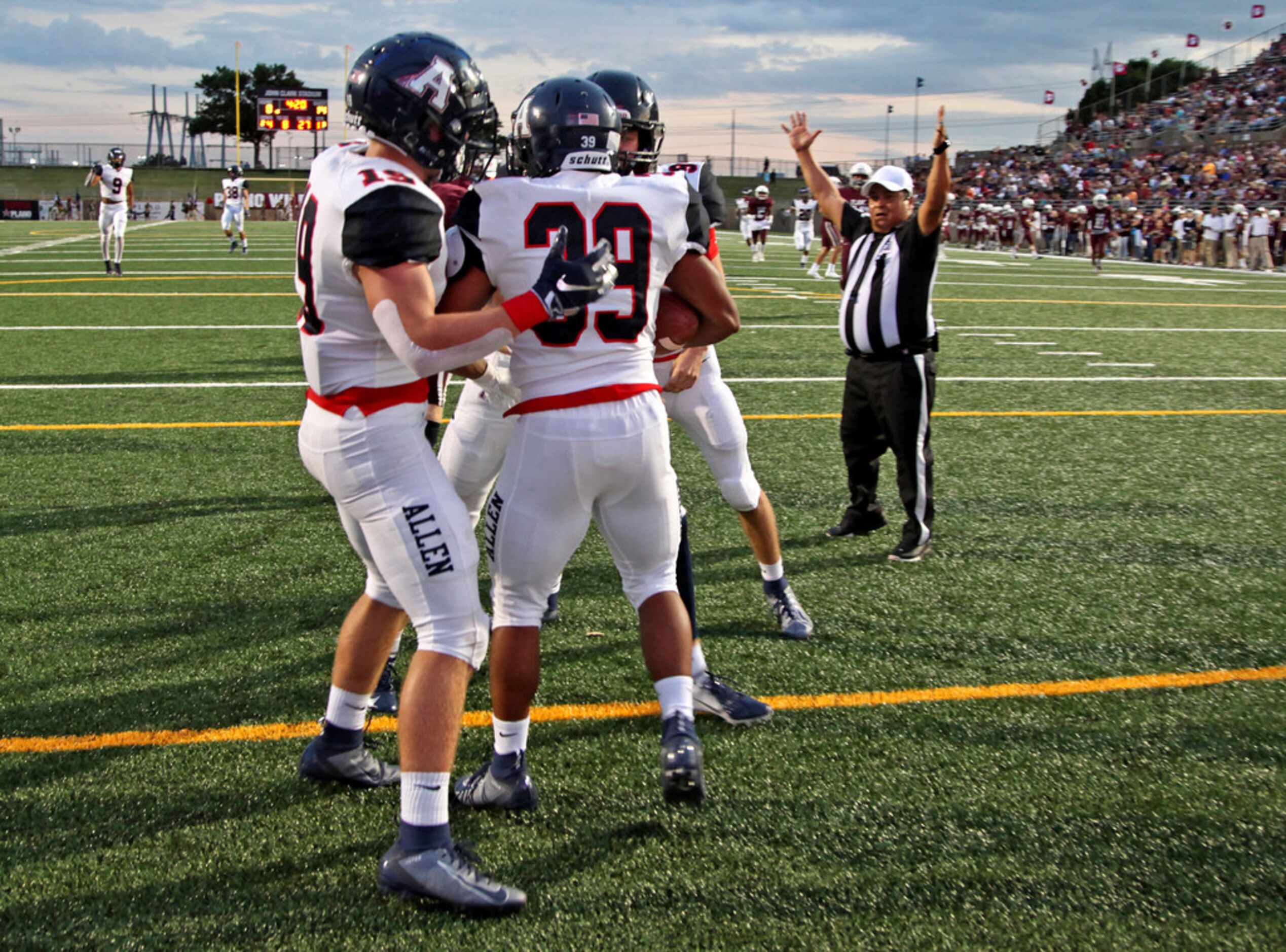 Allen High School linebacker Devin Moore (39) is mobbed by team mates after he blocked a...