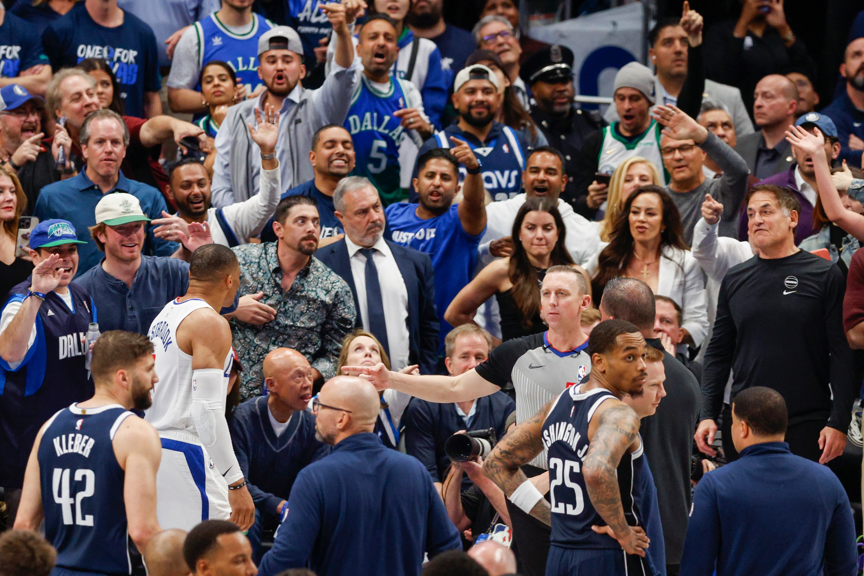 LA Clippers guard Russell Westbrook (0) and Dallas Mavericks minority owner Mark Cuban argue...