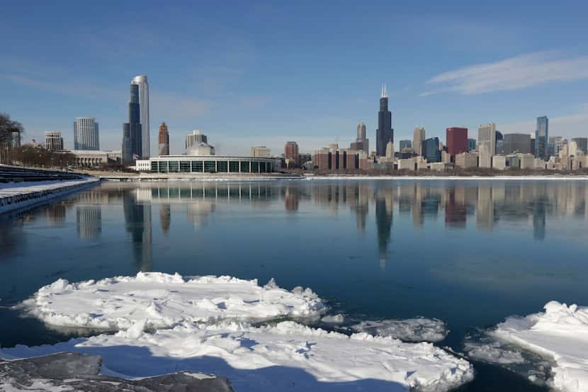 Ice floats on the surface of Lake Michigan Friday, Jan. 3, 2014, in Chicago. Single-digit...