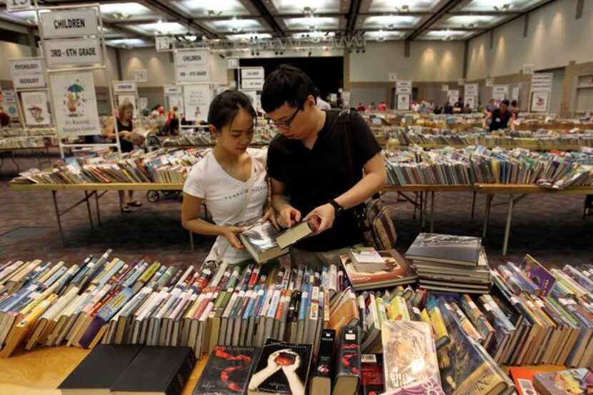 
Dan Yee, left, and Stefan Zhang shop for some new reading material during a Friends of the...