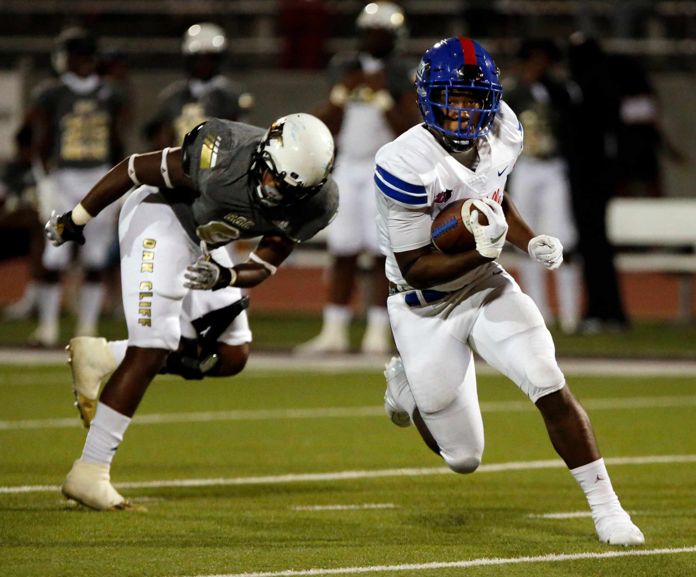 Duncanville’s Malachi Medlock (5) eludes South Oak Cliff’s Adul Muhammad (6) and gains a...