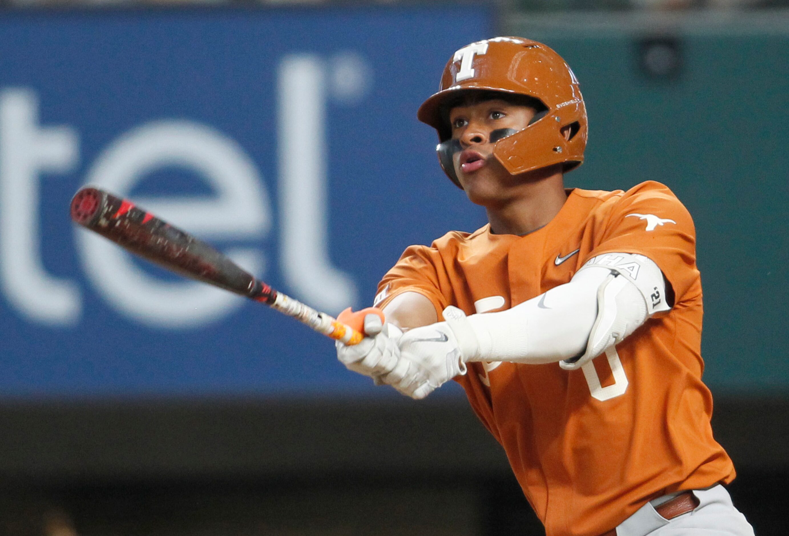 Texas Longhorns shortstop Trey Faltine (0) watches as his long drive to the outfield...