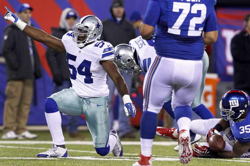 Dallas Cowboys outside linebacker Bruce Carter (54) points to the crowd after stopping New...