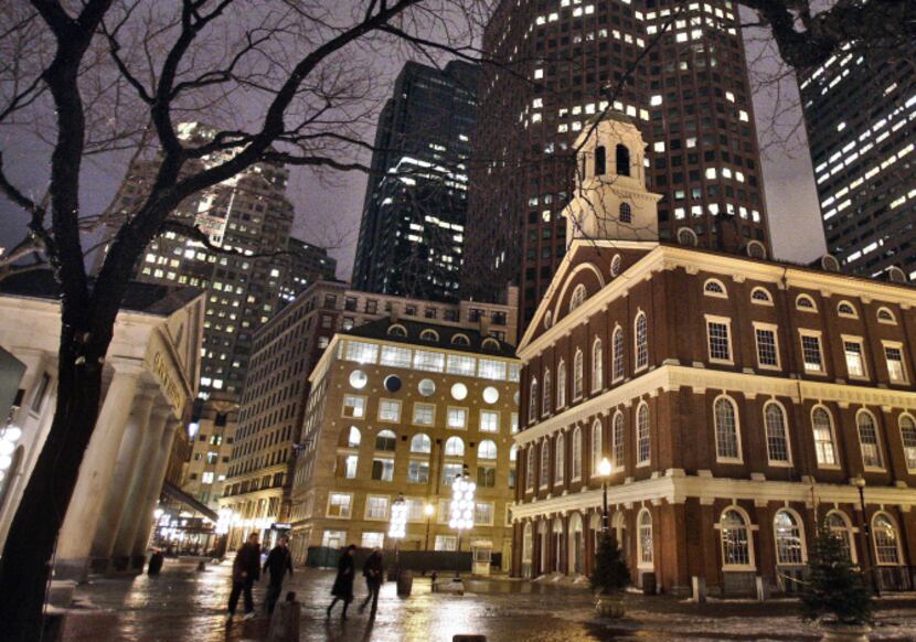  In this Feb. 22, 2007 file photo, Faneuil Hall, right, is seen at night among the buildings...