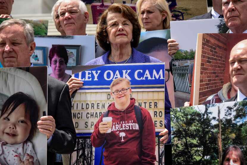Sen. Dianne Feinstein, D-Calif., along with fellow Democratic senators, hold pictures of a...