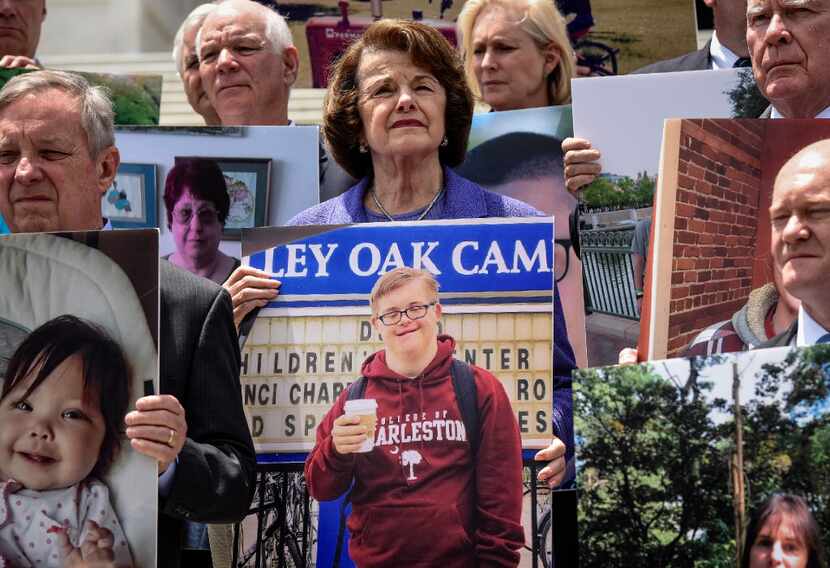 Sen. Dianne Feinstein, D-Calif., along with fellow Democratic senators, hold pictures of a...