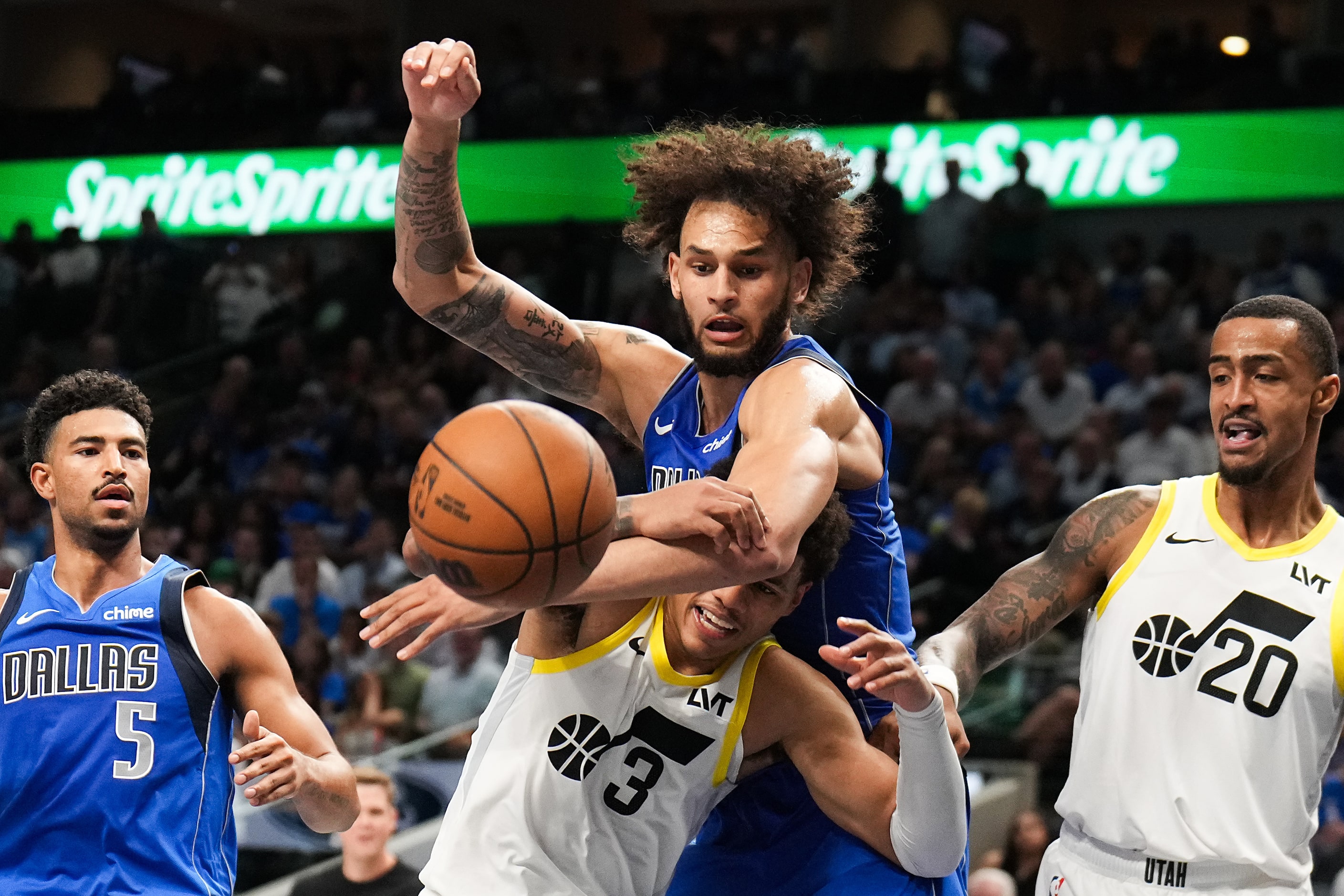 Utah Jazz guard Keyonte George (3) is fouled by Dallas Mavericks center Dereck Lively II (2)...